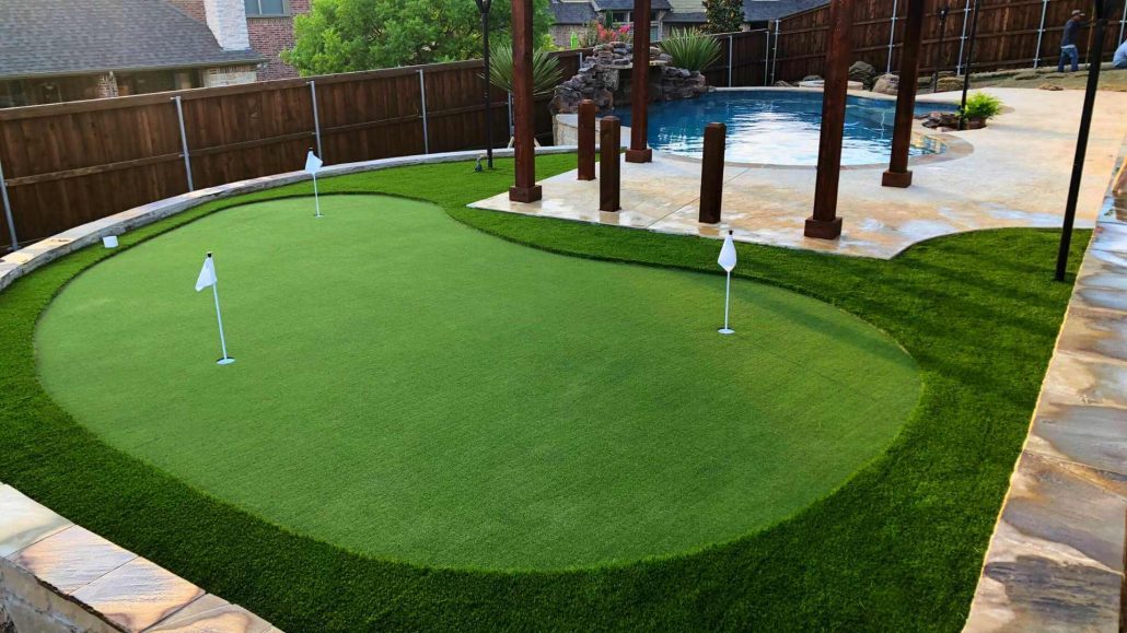 Lush backyard putting green installation